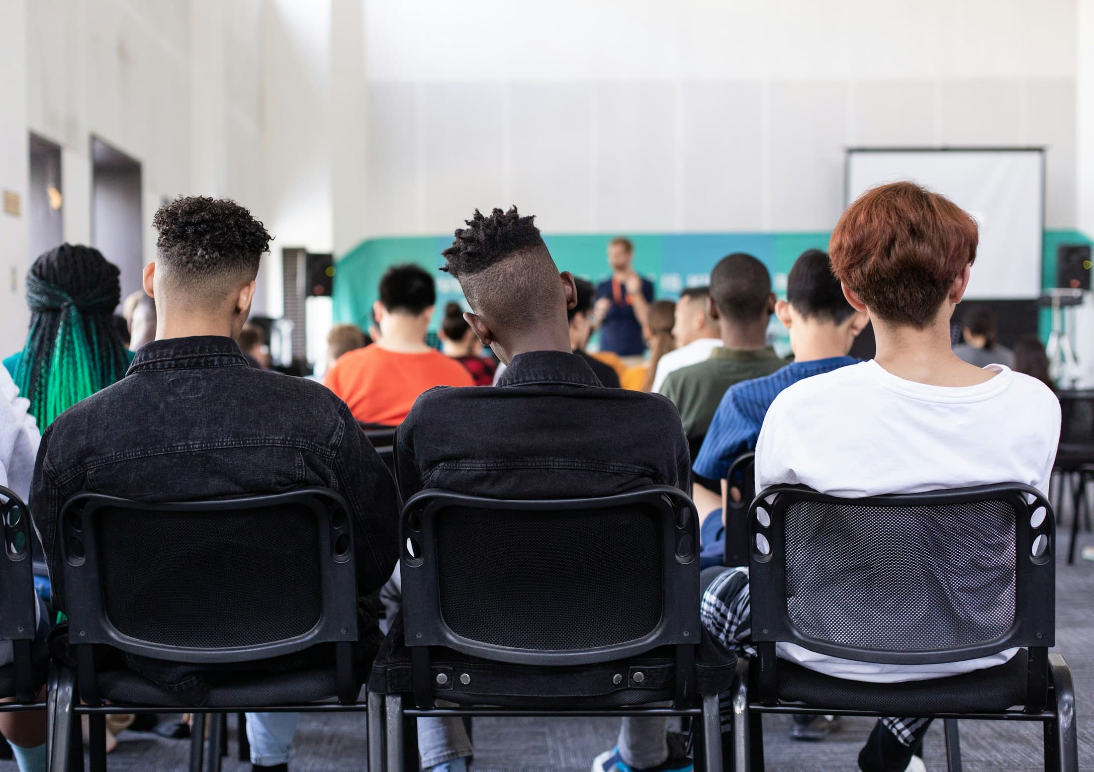Students gathered for a presentation in a bright school space